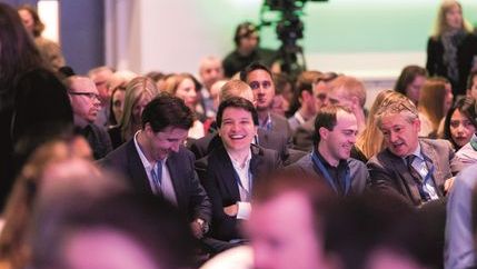 Smiling man in conference crowd