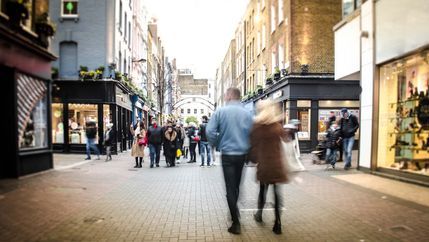 Blurred high street shoppers.