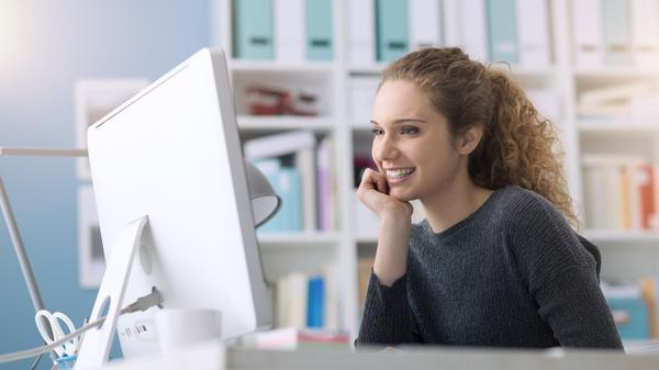 Woman studying at white computer